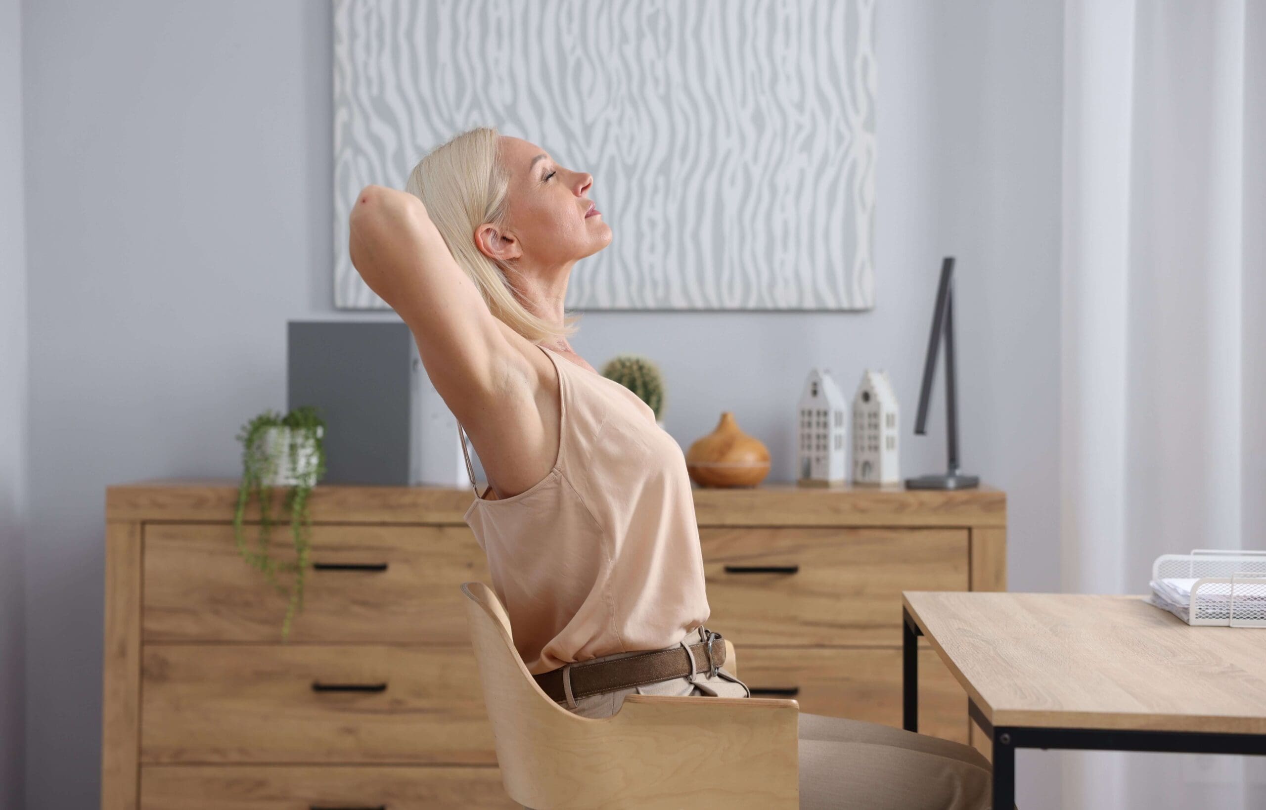 Woman at desk taking a moment to rest — chronic stress and hormone health in Washington DC